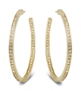 Star-studded style. This elegant pair of gold tone hoop earrings sparkles in clear Swarovski crystal pavé, reflecting the light beautifully and adding a touch of sophistication to any outfit. Approximate diameter: 1-7/8 inches.