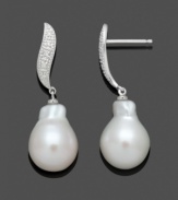 Beauty at its finest. Belle de Mer's Baroque-style drop earrings highlight a cultured freshwater pearl (11-12 mm) and a swirling post setting dusted with diamond accents. Crafted in 14k white gold. Approximate drop: 1-1/4 inches.