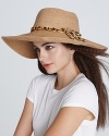 Chic style starts with an oversized sun hat accented by a chain woven chiffon belt. By Eugenia Kim.