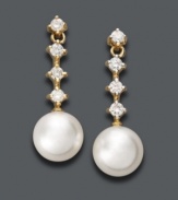 Perfect your evening wear with elegant drops. Belle de Mer earrings features a cultured freshwater pearl (8-9 mm) highlighted by four, round-cut diamonds (1/3 ct. t.w.). Crafted in 14k gold. Approximate drop: 3/4 inch.