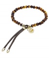 Slip-on stackable style! Michael Kors' chic stretch bracelet brings natural appeal with tortoise acetate beads and gold tone brass accents. Finished with gold-tone tipped, adjustable leather clasp. Approximate diameter: 2-1/4 inches.