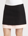 A contrasting layer peeks out from underneath this ultra-short, woven mini skirt.Side zipperSlash pocketsLayered-look hemAbout 15 from natural waistCottonDry cleanImportedModel shown is 5'10 (177cm) wearing US size 4. 