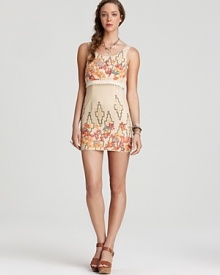This Free People mini dress masters bohemian-luxe style with a bold floral print and metallic sheen. This Free People mini dress masters bohemian-luxe style with a bold floral print and metallic sheen.