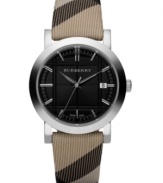 This Burberry timepiece features a Nova check fabric strap and round stainless steel case. Etched black dial with silvertone stick indices, logo and date window. Swiss made. Quartz movement. Water resistant to 50 meters. Two-year limited warranty.