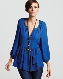 A lush French Connection top infuses your day with brilliant color and ladylike style, flaunting pleating at the shoulders and blouson sleeves--but it's the ruffled hem with patch pockets that steals the show. A lush French Connection top infuses your day with brilliant color and ladylike style, flaunting pleating at the shoulders and blouson sleeves--but it's the ruffled hem with patch pockets that steals the show.