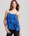 Lush asymmetric ruffles cascade through the silhouette of this Alice + Olivia tank for a playful season of flirtatious looks.