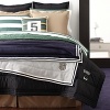 The pieced construction of the chino bedding lends a structured yet casual feel to the polished preppy elements of Lauren's University collection.