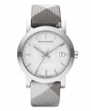 This Burberry timepiece features a pale trench smoked degrade check strap and round stainless steel case. Light gray dial with checked pattern features silver tone stick indices, black minute track, date window at three o'clock, three hands and logo. Quartz movement. Water resistant to 50 meters. Two-year limited warranty.