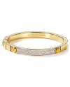 This Michael Kors bangle elevates simple style in gold tone plated metal with delicate crystal stones. Slip it on for a hit of minimalist glamour.