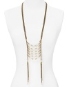 This Vanessa Mooney brass link necklace makes a bold statement with its bone accents and long, tassel trimmed silhouette. Slip it on to take your look from day to darkly glam.