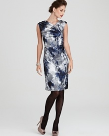 An abstract floral print on shimmering satin creates this Jones New York sheath dress, finished with pretty pleating and gathering at the neck and sides.