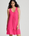 A basic sleeveless chemise with a pleated front and ruffle hem.