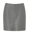 Rock n roll style gets a sophisticated makeover with this sleek grey leather mini-skirt from Cacharel - Mini-length, front seam with tonal stitching, concealed back zip closure - Wear with an oversized blouse, ribbed tights, and high-heel booties