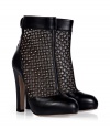 Take a rocker-chic stance on sophistication this season in Valentinos studded ankle boots, accented with sleek black leather trim for an edgy elegant finish - Rounded toe, snapped ankle strap with cut-out, back zip, blocky heel - Pair with leather leggings and chunky modern knits