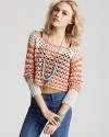 A new Free People sweater has cropped up, rendered in a sheer, loose knit and boasting refreshing orange stripes. Layer the piece over a tank and pair with your favorite jeans--it's weekend-perfect for the transitional season.