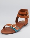 Slip on these VINCE CAMUTO sandals for fashionable summer excursions--crafted in luxe leather and boasting a pop of color at the toe, this ankle-wrap silhouette offers effortless style.