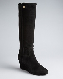 Tory Burch will take you places in these tall wedge boots embellished with subtle yet eye-catching logo details. Tory Burch will take you places in these tall wedge boots embellished with subtle yet eye-catching logo details.