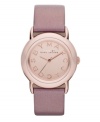 Tastefully trendy. The perfect amount of pink shimmer warms up this watch by Marc by Marc Jacobs. Metallic blush leather strap and round rose-gold ion-plated stainless steel case. Rose-gold tone mirrored dial features rose-gold tone logo letters at markers and three hands. Quartz movement. Water resistant to 50 meters. Two-year limited warranty.