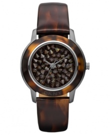 A modern watch design from DKNY with eye-catching neutral-hued stones at the dial. A modern watch design from DKNY with eye-catching neutral-hued stones at the dial.