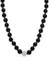 A traditional style with sleek, modern appeal. This smooth strand showcases shiny onyx beads (10 mm) and a sparkling crystal ball at center (12 mm). Clasp crafted in sterling silver. Approximate length: 18 inches.