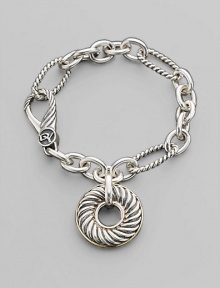 A doughnut-shaped cabled charm on a bold sterling silver chain of smooth and textured links, with accents of 18k gold. Sterling silver and 18k yellow gold Bracelet length, about 7½ Charm diameter, about 1 Spring clip clasp Made in USA A doughnut-shaped cabled charm on a bold sterling silver chain of smooth and textured links, with accents of 18k gold. Sterling silver and 18k yellow gold Bracelet length, about 7½ Charm diameter, about 1 Spring clip clasp Made in USA
