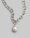 A lustrous white cultured pearl in a graceful cable frame makes an elegant addition to your own necklace or bracelet. White cultured pearl Sterling silver Diameter, about ½ Spring clip clasp Imported Please note: Necklace sold separately.