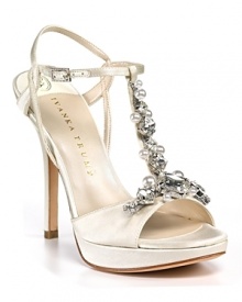 Softly shimmering satin t-straps go glam with the addition of bold, faceted rhinestones. By IVANKA TRUMP. Softly shimmering satin t-straps go glam with the addition of bold, faceted rhinestones. By IVANKA TRUMP.