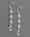 A luxurious look from Givenchy. These silvertone mixed metal earrings feature faceted briolette stones at the end of the drop. Each measures approximately two inches long.