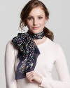 Make an elegant statement with a floral and Gancini printed silk scarf from Salvatore Ferragamo.