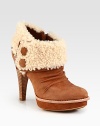 Cozy shearling defines this suede platform silhouette with a towering stacked heel, side zip and covered buttons. Stacked heel, 4¾ (120mm)Suede platform, 1 (25mm)Compares to a 3¾ heel (95mm)Suede upper with foldover shearling liningSide buttons and side zipShearling liningLeather and rubber solePadded insoleImported