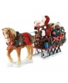 All aboard! Santa takes a few friends along for a sleigh ride. A festive dressed horse leads the way for the magical journey through town.