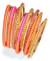 Decorate your wrists with the shimmering colors of summer sunshine. This Bar III bracelet set is a beautiful collection of 15 plastic and mixed metal fabric-wrapped and beaded bracelets in bright orange and pink hues. Approximate diameter: 2-1/2 inches.