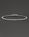 Glittering diamonds flow over 18K white gold.