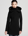 A voluminous funnel collar and leather accents lend luxe style to this A-line coat from Mackage.
