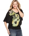 A refreshing floral print illuminates Style&co.'s butterfly sleeve plus size top, punctuated by a smocked hem.