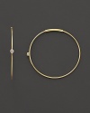 Single diamonds wink from the center of these delicate 14K gold hoops.