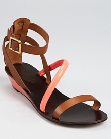 A vibrant neon orange band extends across these trend-right Juicy Couture sandals, a polished silhouette with a timeless air and playful details. A vibrant neon orange band extends across these trend-right Juicy Couture sandals, a polished silhouette with a timeless air and playful details.