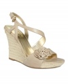 Always a lady. With a rosette detail and beautifully curved straps, the Latonia sandals by Guess are the season's most graceful wedge. (Clearance)