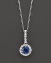 Diamonds surround a sapphire center stone in this elegant 14K white gold pendant necklace.