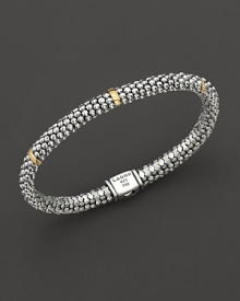 Sterling silver Caviar™ beaded oval rope bracelet with five gold stations with logo box clasp closure. Designed by Lagos. Sterling silver Caviar™ beaded oval rope bracelet with five gold stations with logo box clasp closure. Designed by Lagos.