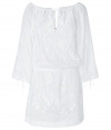 Romantic white tunic top is perfect for summer days - Drawstring creates sweets, flirtatious round neckline with tie closure -  Wide, 3/4-length sleeves feature ties - Enhanced waist - White-on-white floral embroidery with eyelets - Pair with skinny jeans or leggings and simple sandals for a relaxed warm-weather look