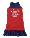 A sporty tank dress with heritage flair features a color-blocked design and an athletic graphic print.