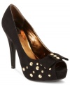 Studded out and gorgeous. G by GUESS's Roxxan platform pumps feauture studs along the vamp and on the pretty platform peep toe.
