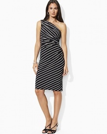 The timeless glamour of a one-shoulder silhouette is elegantly captured on a sleek matte jersey dress, finished with delicate ruching for a stunning look. The timeless glamour of a one-shoulder silhouette is elegantly captured on a sleek matte jersey dress, finished with delicate ruching for a stunning look.