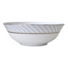 Carefully rendered in a style reminiscent of neoclassic trompe l'oeil-a French term for artwork that depicts optical illusions-a captivating geometric rosette motif traverses this elegant porcelain salad bowl from Bernardaud. Delicate shades of ice blue, mother-of-pearl and gray are enhanced by a fine platinum trim.