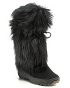 Bold and cozy, Pajar's shaggy goat hair boots are topped with tassels and lined with soft, warm shearling.