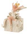 Let your imagination take flight with a hint of pixie dust. Never Land's illustrious fairy, Tinkerbell, strikes a joyful pose atop a beautifully embossed gift. In ivory porcelain with swirls of gold, this Lenox figurine makes Disney magic happen at home. Qualifies for Rebate