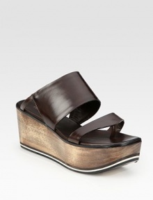 Burnished leather slide enhanced by a natural wooden wedge, slight thong front and foam insert. Wooden wedge with foam insert, 3 (75mm)Wooden platform with foam insert, 1½ (40mm)Compares to a 1½ heel (40mm)Leather upperLeather lining and solePadded insoleMade in ItalyOUR FIT MODEL RECOMMENDS ordering one half size up as this style runs small. Burnished leather slide enhanced by a natural wooden wedge, slight thong front and foam insert. Wooden wedge with foam insert, 3 (75mm)Wooden platform with foam insert, 1½ (40mm)Compares to a 1½ heel (40mm)Leather upperLeather lining and solePadded insoleMade in ItalyOUR FIT MODEL RECOMMENDS ordering one half size up as this style runs small.