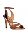 Bring instant chic to your look with these ultra luxe sandals from Salvatore Ferragamo - Front strap with crisscross detail, metallic side detail, ankle strap with buckle closure, snake embossed leather heel - Pair with a floral print mini dress, a cashmere cardigan, and a statement clutch