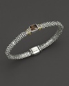 From the Glacier collection, thin caviar rope bracelet with centered smoky topaz stone and gold accents. Designed by Lagos.